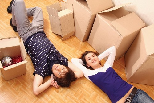 Team unloading furniture at a new home during house removals in Crewshill